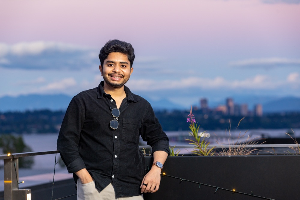 Sanket Gautam at dusk, with the skyline and Lake Washington behind him